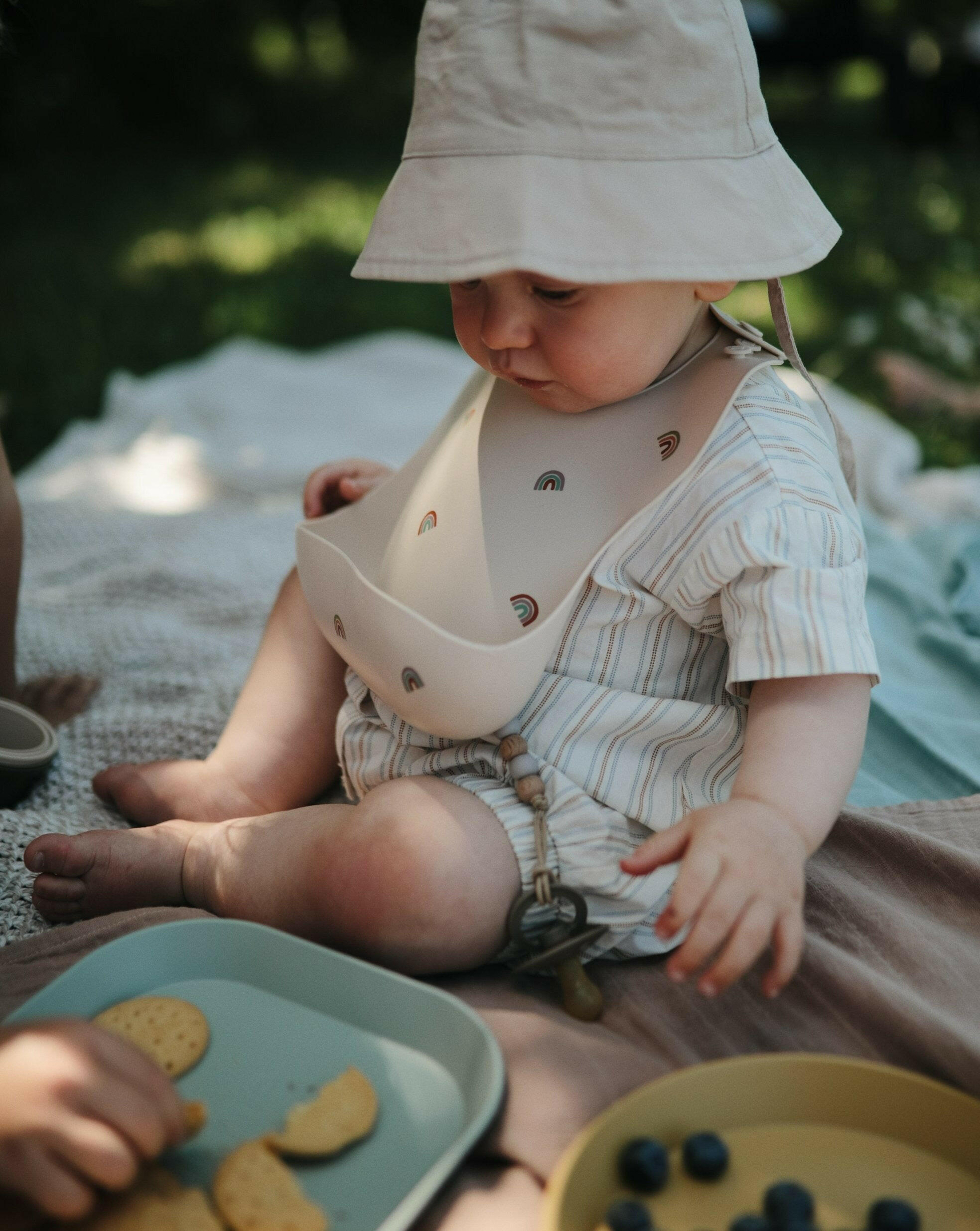 Silicone Baby Bib - Rainbows feeding Mushie