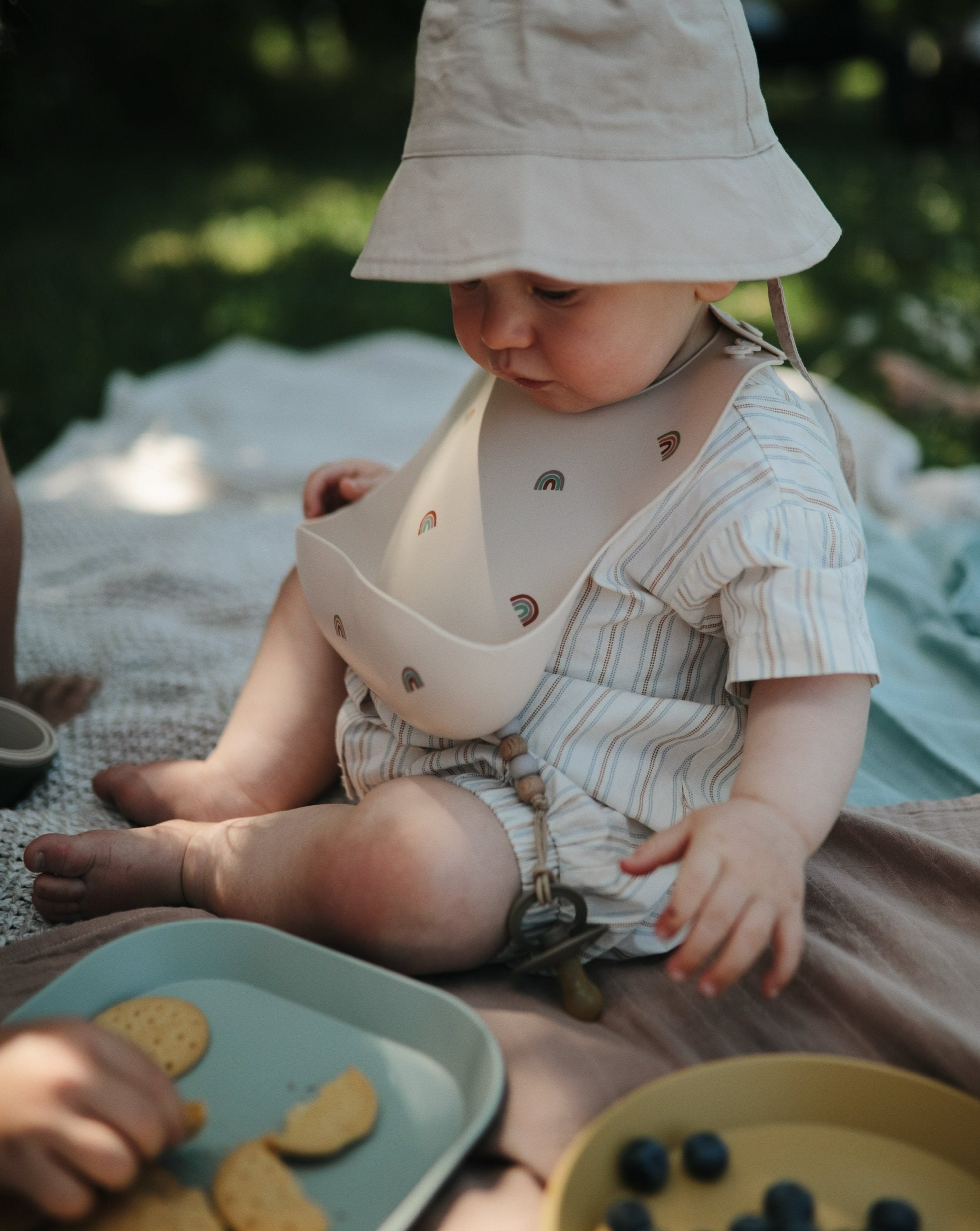 Silicone Baby Bib - Rainbows feeding Mushie   